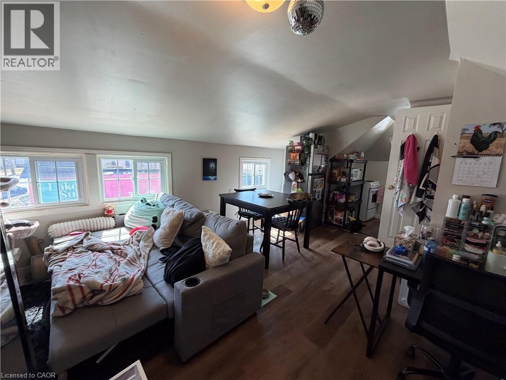 A living room with a couch, a table, and a chair.