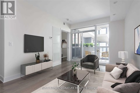 A modern living room with a glass coffee table and a flat screen TV mounted on the wall.