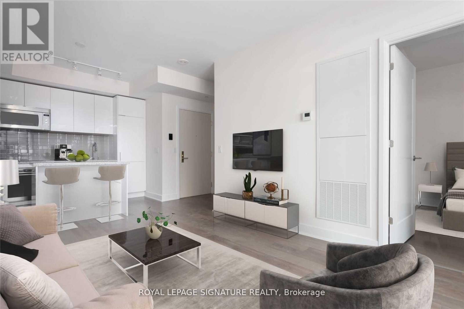 A modern living room with a grey couch and a coffee table.