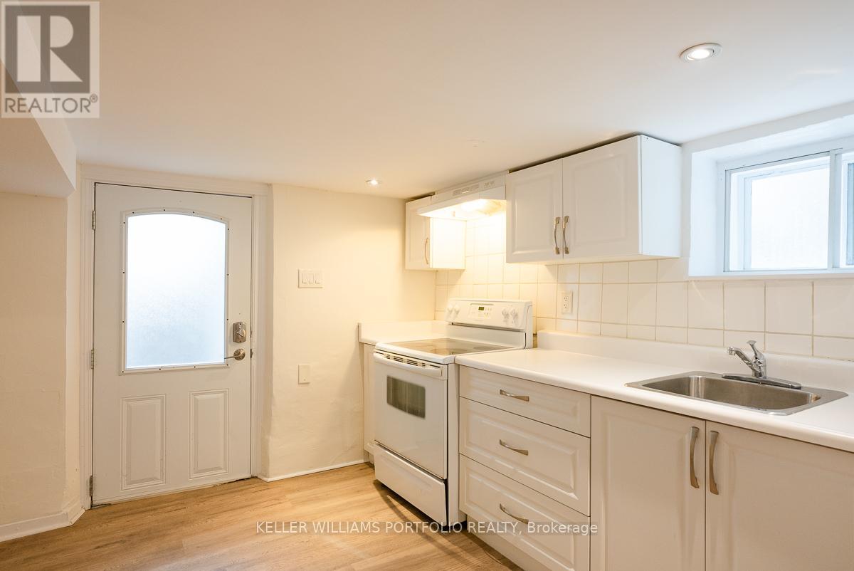 A kitchen with white cabinets and a white oven.