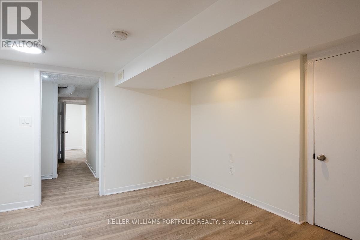 A hallway with wood floors and white walls.