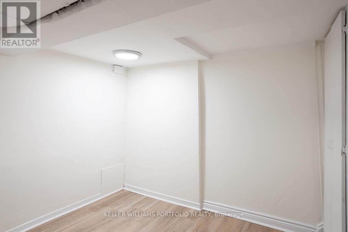 A white empty room with a light on the ceiling.