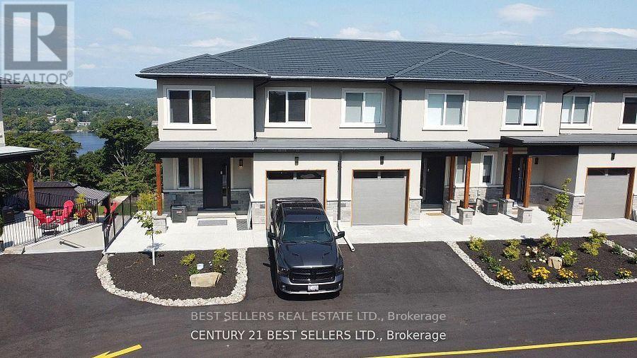 A modern house with a black car parked in front.