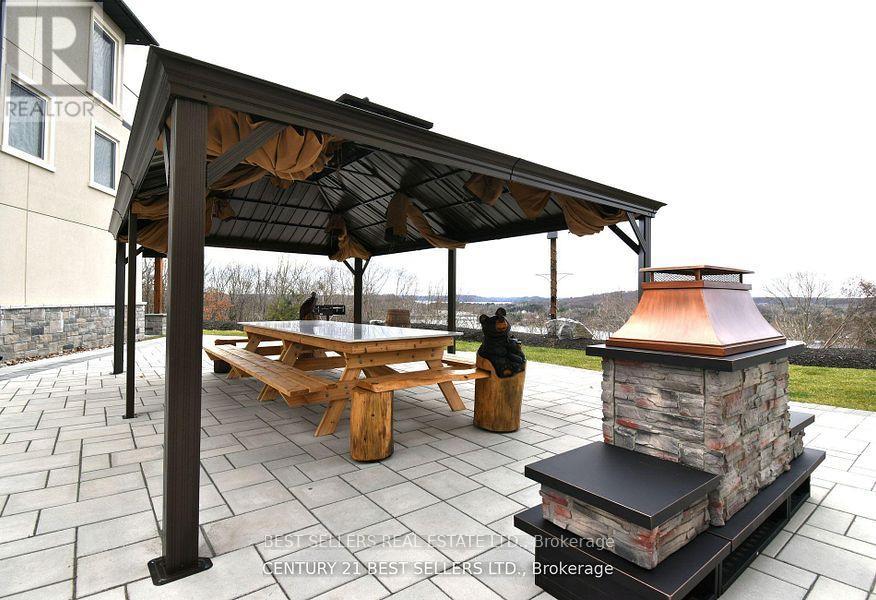 A patio with a table and chairs under a roof.