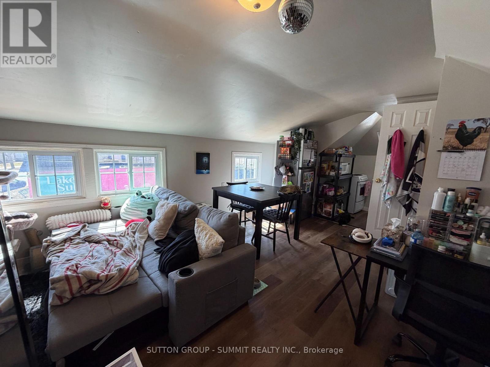 A living room with a couch, a table, and a window.