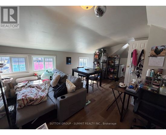 A living room with a couch, a table, and a window.