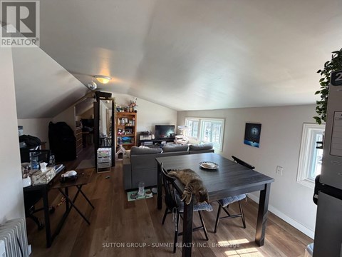 A living room with a dining table and chairs.
