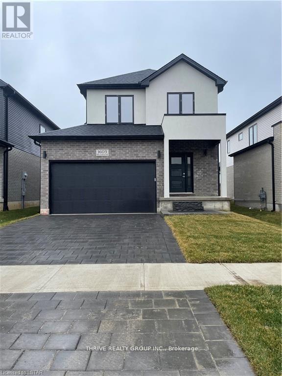 A house with a black garage door is for sale.