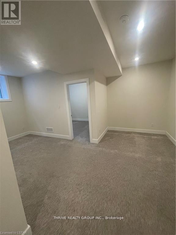 A room with a carpeted floor and a door in the middle.