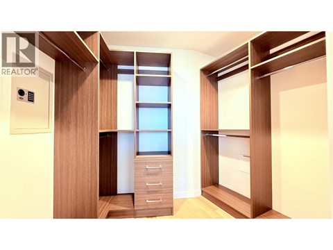 A modern kitchen with wooden cabinets and drawers.