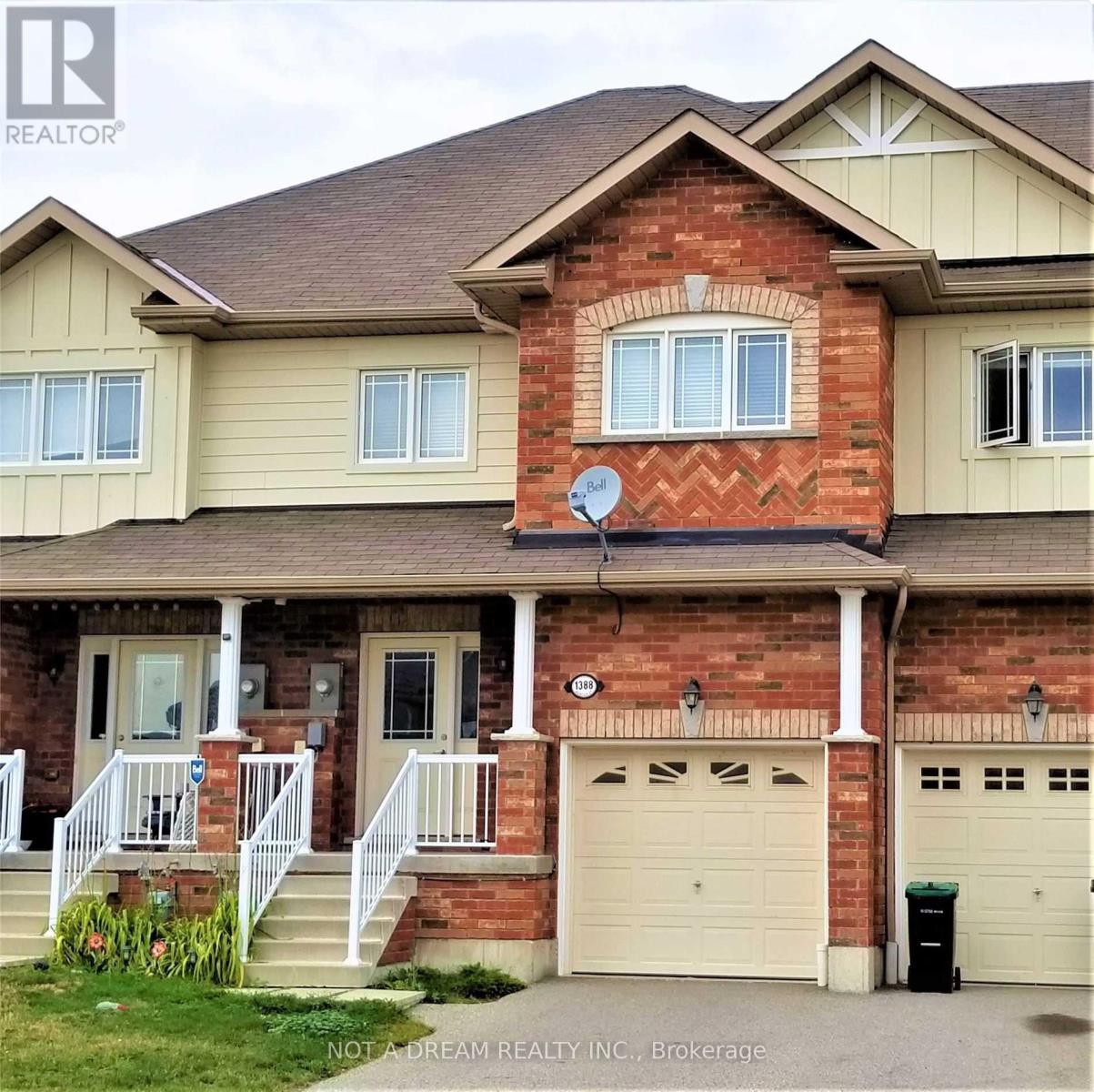 A house with a garage and a satellite dish on the roof.