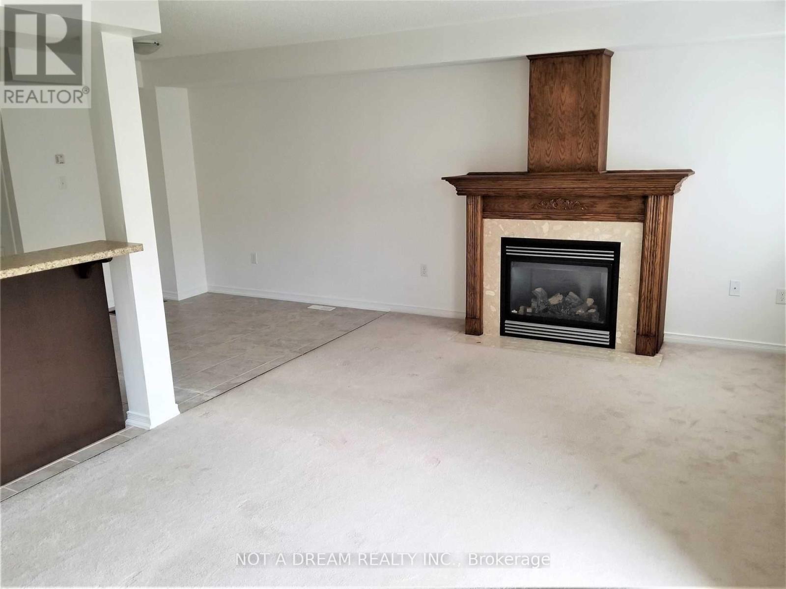 A living room with a fireplace and a sign that says "NOT A DREAM REALTY INC. REALTOR".