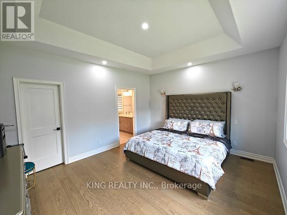 A bedroom with a bed, dresser, and mirror.