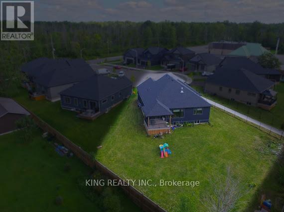 A bird's eye view of a residential area with houses and a playground.