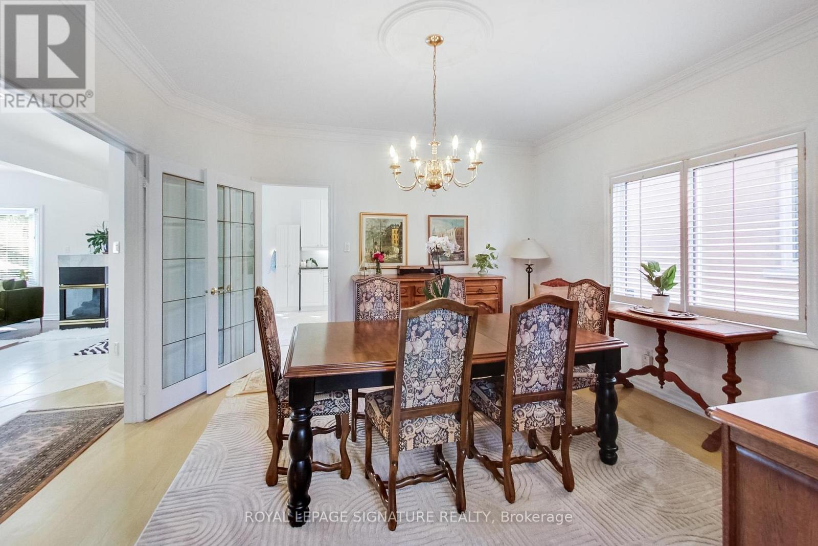 A dining room with a wooden table and chairs.