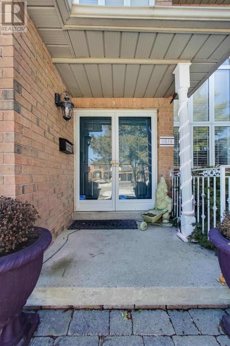 A house entrance with a glass door and a white fence.