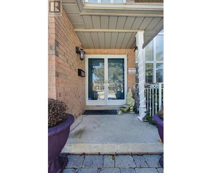 A house entrance with a glass door and a white fence.