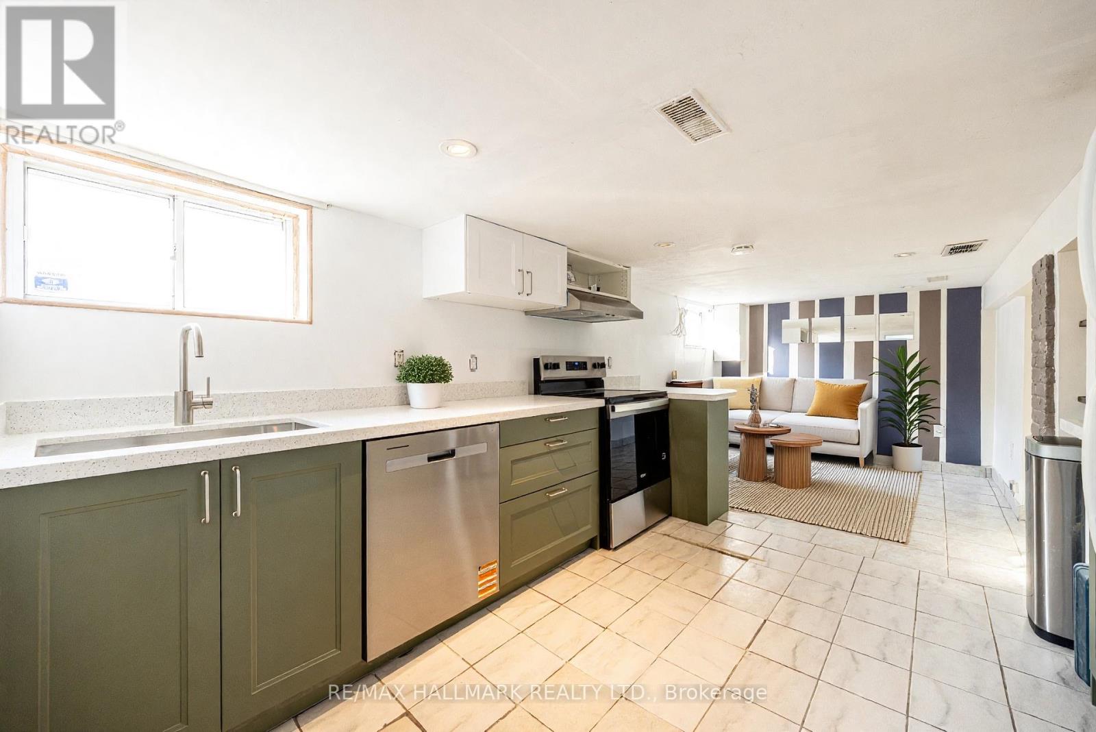 A kitchen with green cabinets and stainless steel appliances.