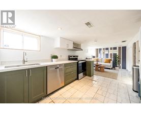 A kitchen with green cabinets and stainless steel appliances.