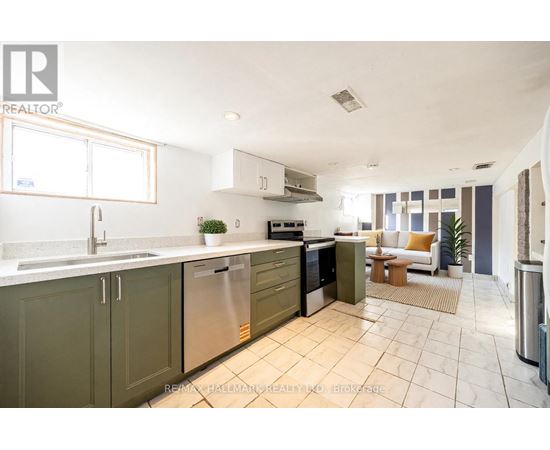 A kitchen with green cabinets and stainless steel appliances.