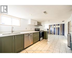 A kitchen with green cabinets and a white counter top.