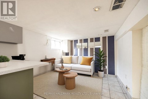 A living room with a white couch and a wooden coffee table.