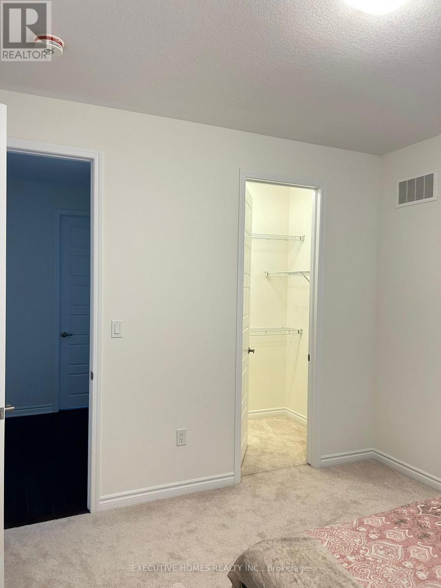 A bedroom with a bed and a closet.