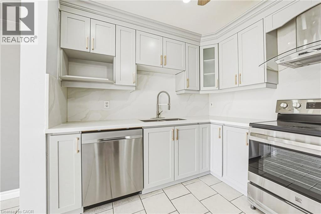 A kitchen with white cabinets and stainless steel appliances.