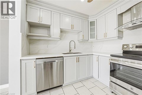 A kitchen with white cabinets and stainless steel appliances.