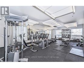 A well-equipped gym with various exercise machines and weights.