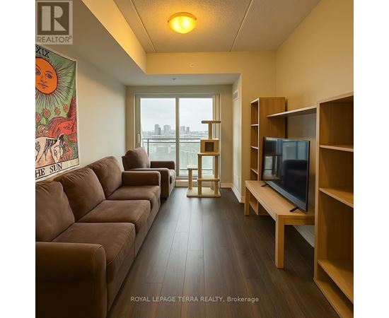 A living room with a brown couch and a television.