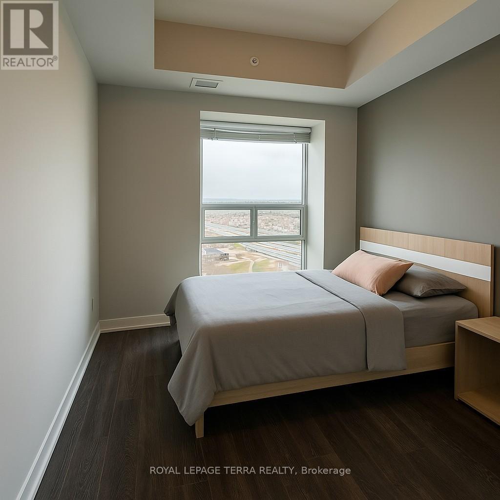 A bedroom with a bed, nightstand, and window.