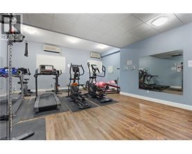 A gym with treadmills, exercise bikes, and other equipment.
