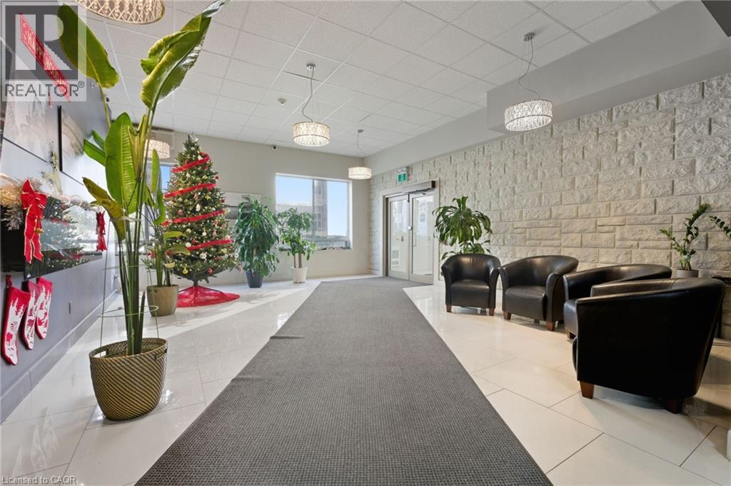 A long hallway with a Christmas tree and a REALTOR sign on the wall.