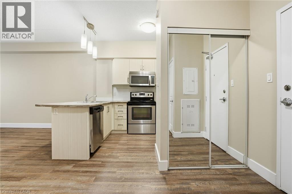 A kitchen with a white counter top and a stainless steel oven.