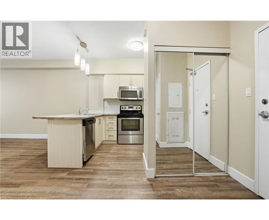 A kitchen with a white counter top and a stainless steel oven.