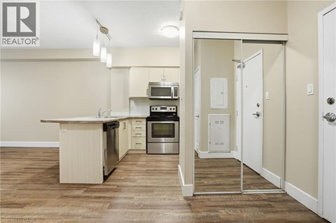 A kitchen with a white counter top and a stainless steel oven.