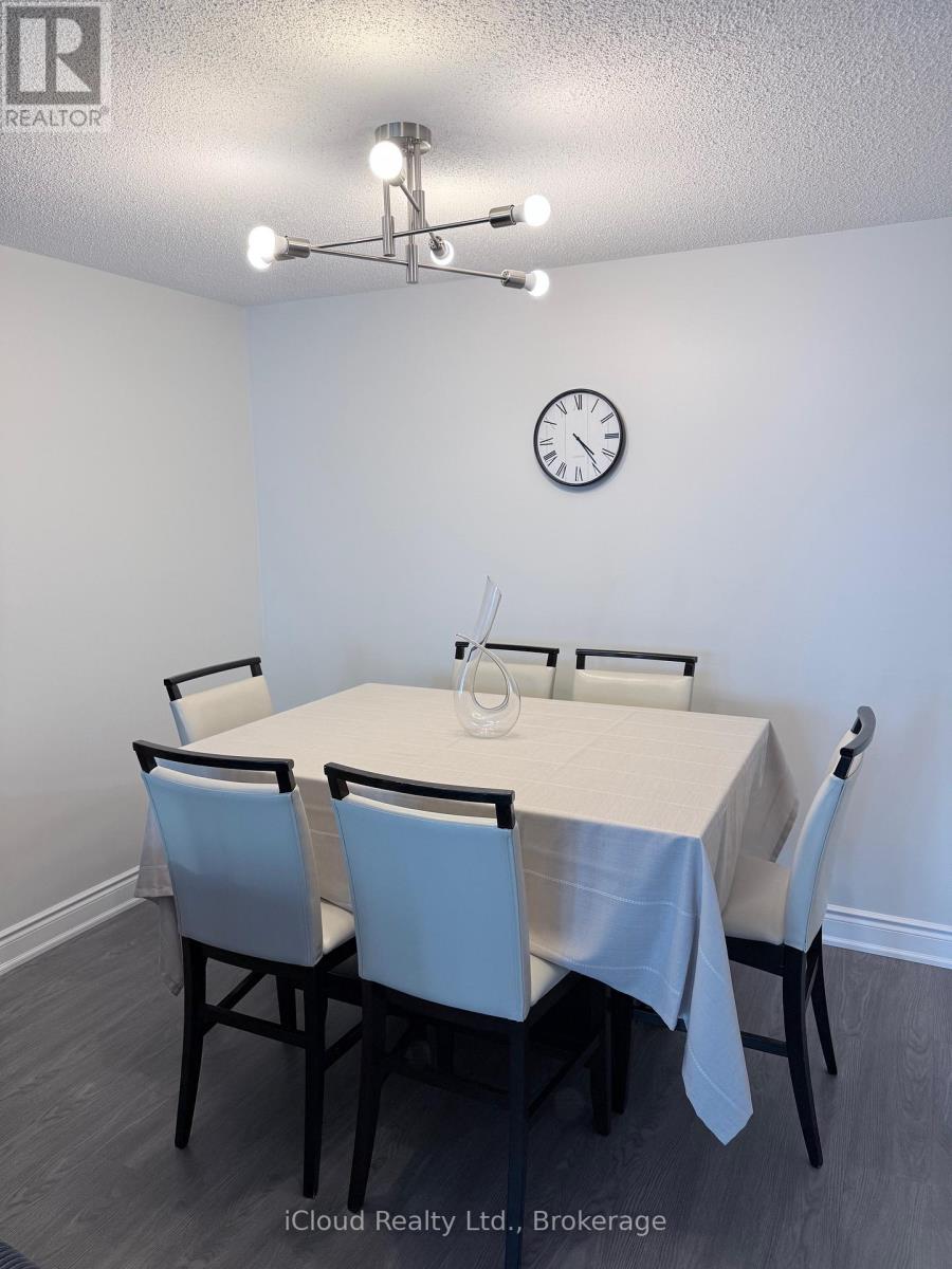 A dining room with a table set for four.