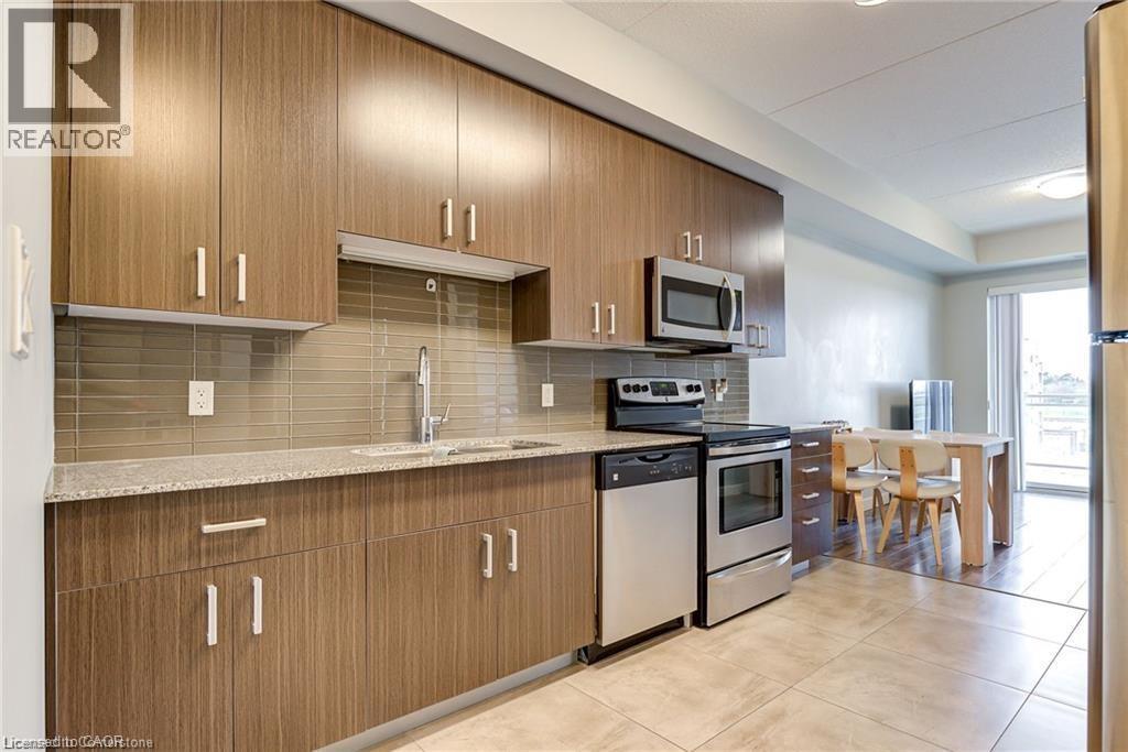 A kitchen with wooden cabinets and a tile backsplash.