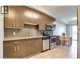 A kitchen with wooden cabinets and a tile backsplash.