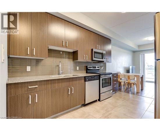 A kitchen with wooden cabinets and a tile backsplash.