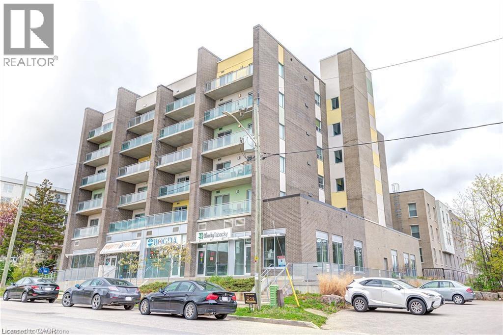 A multi-story building with cars parked in front.