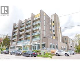 A multi-story building with cars parked in front.