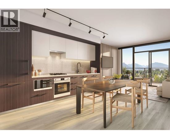 A modern kitchen with a dining table and chairs.