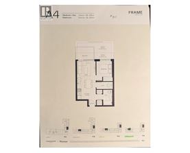 A framed drawing of a floor plan for a property with a kitchen, living room, and bathrooms.