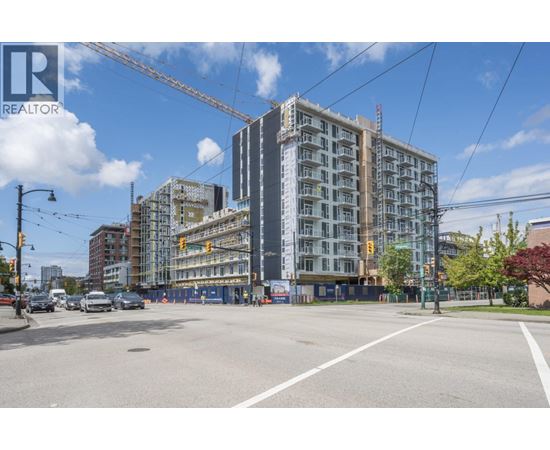 A construction site with a crane and a building under construction.