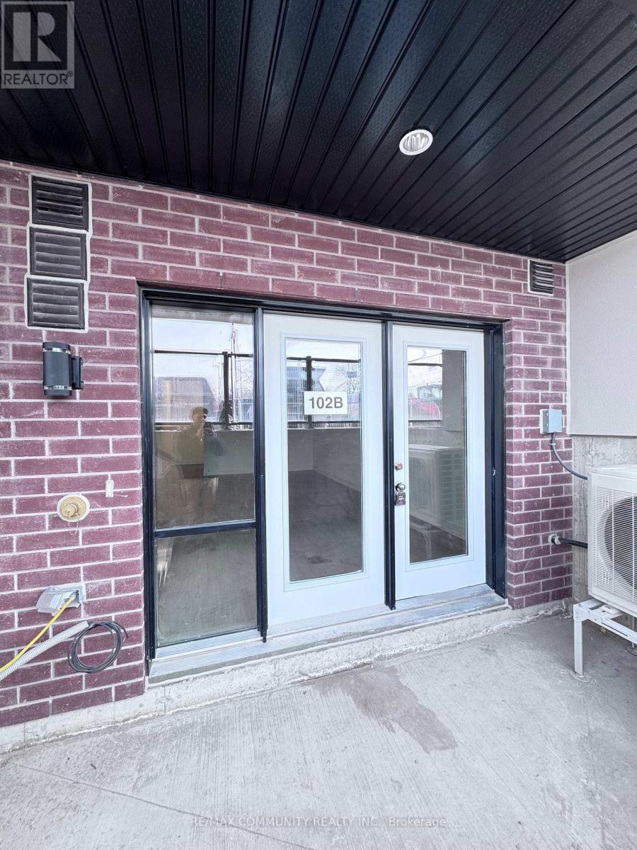 A glass door with a number 102B on it.