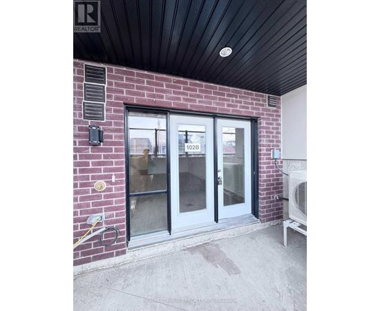 A glass door with a number 102B on it.