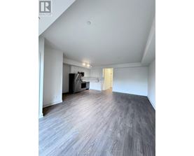 A spacious room with a grey floor and white walls.