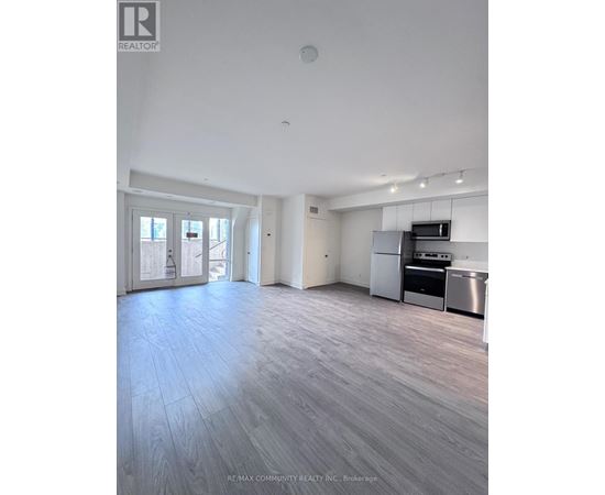 A spacious kitchen with stainless steel appliances and a dining area with a table and chairs.